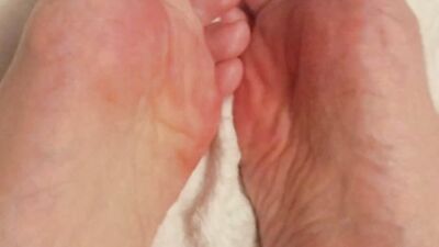 Putting lotion on my tiny, pale feet after showing them off in my favourite socks