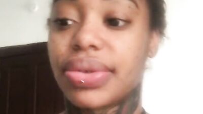 Inked ebony lady shakes her massive tits and ass for the camera