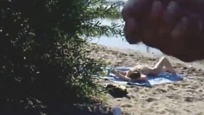 Creepy guy jerks off and jizzes on sunbathing naked girl