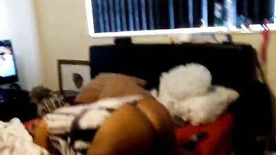 Big black woman shakes ass and rides her man while watching TV