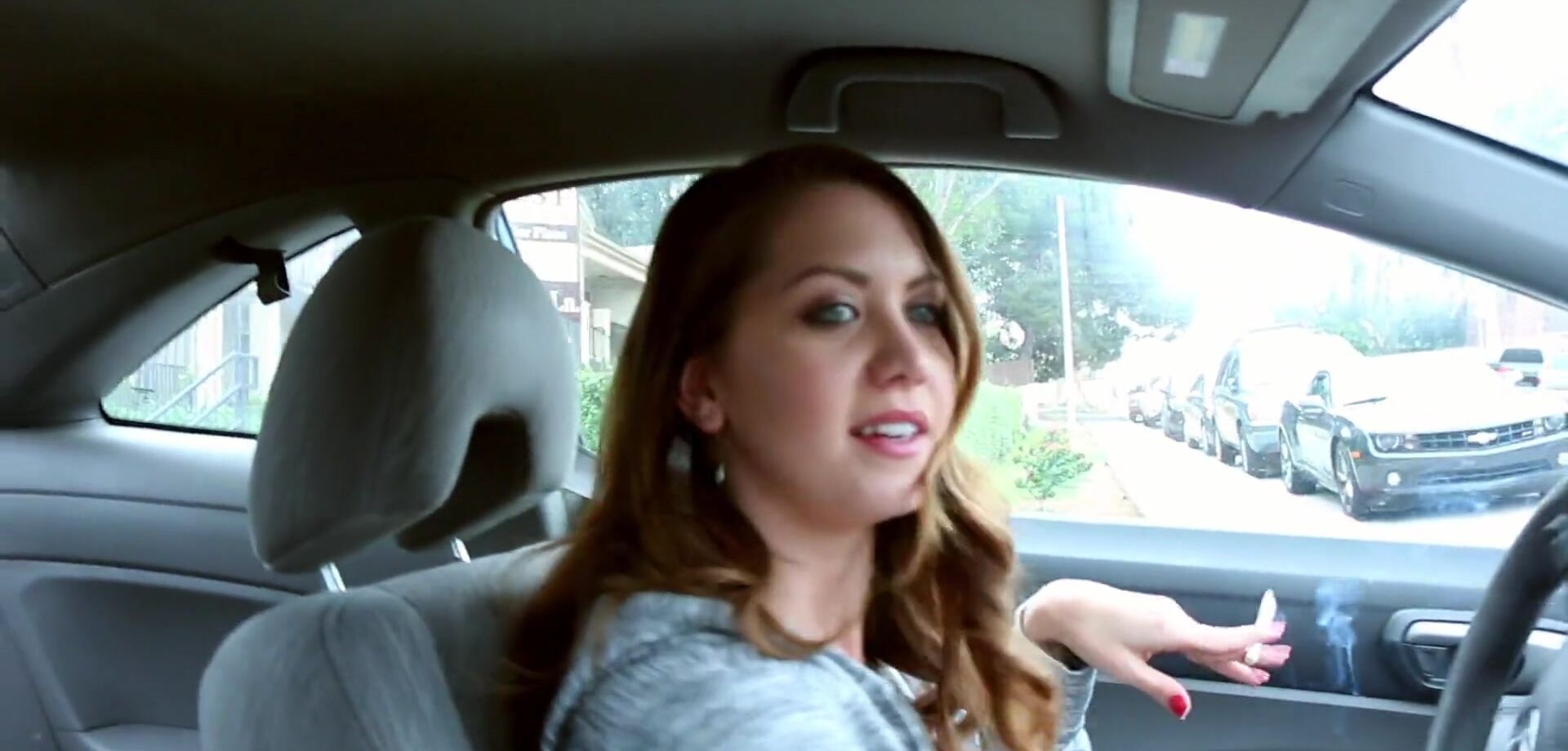 Chrissy Marie is smoking a cigar while driving a car - MomVids.com