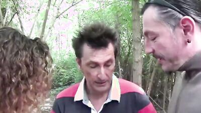 German MILF is poked in the woods with two hard peckers