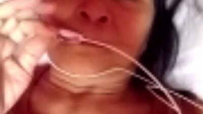 Chubby mature woman is talking dirty while masturbating over the camera