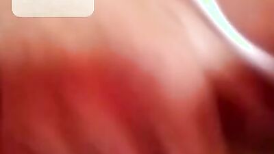 Chubby mature woman is talking dirty while masturbating over the camera