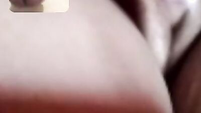 Chubby mature woman is talking dirty while masturbating over the camera