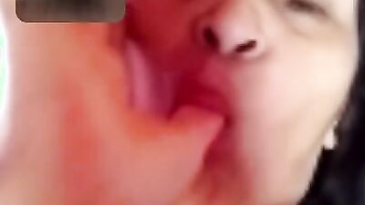 Chubby mature woman is talking dirty while masturbating over the camera