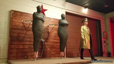 Two helpless girls are tightly wrapped and left to struggle
