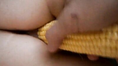 Cougar enjoys while partner pushes a corn up her pussy
