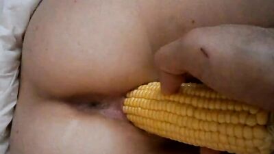 Cougar enjoys while partner pushes a corn up her pussy