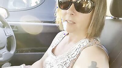 Hitchhiker MILF grabs driver's cock and blows him in the car