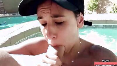 Sweet girl is sucking a massive hard cock in the pool