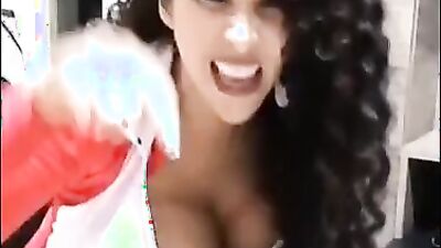 Curly-haired MILF is playing with herself in front of the camera