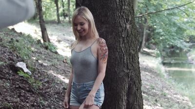 Cock-teasing blonde girl is stripping and posing in the woods