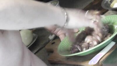 Chubby mature woman is filmed while cooking naked in the kitchen