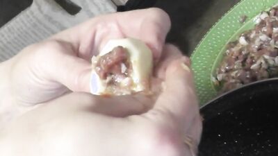 Chubby mature woman is filmed while cooking naked in the kitchen