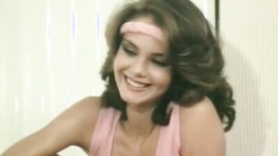 Two ravishing ladies are kissing and licking in a classic porn video
