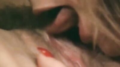 Two ravishing ladies are kissing and licking in a classic porn video