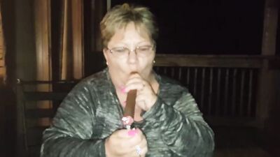 Amateur mature is smoking a cigarette in front of the camera