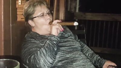 Amateur mature is smoking a cigarette in front of the camera