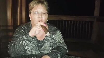 Amateur mature is smoking a cigarette in front of the camera
