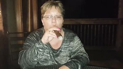 Amateur mature is smoking a cigarette in front of the camera