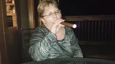 Amateur mature is smoking a cigarette in front of the camera