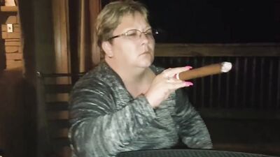 Amateur mature is smoking a cigarette in front of the camera