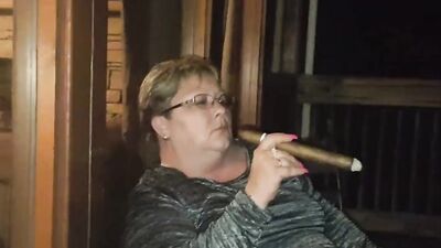 Amateur mature is smoking a cigarette in front of the camera
