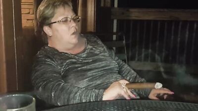 Amateur mature is smoking a cigarette in front of the camera