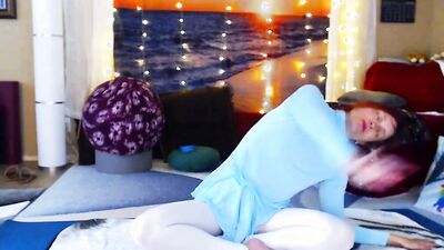 Redheaded babe is practicing yoga in front of the cam