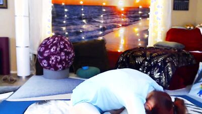 Redheaded babe is practicing yoga in front of the cam
