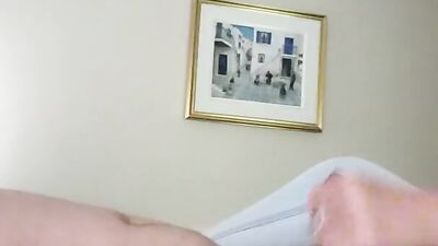 Dude films himself while stroking his hard pecker in the bedroom