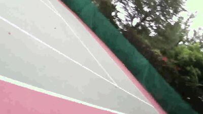 Two babes and one guy are having sex on a tennis court